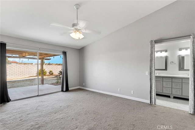 unfurnished bedroom with ensuite bath, light colored carpet, access to outside, ceiling fan, and lofted ceiling