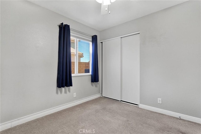 unfurnished bedroom with carpet and a closet