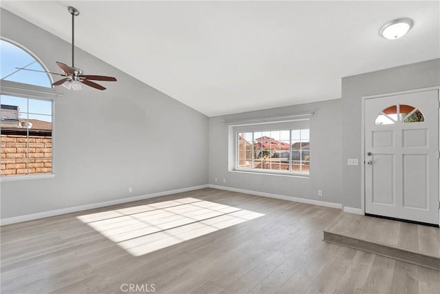 foyer with ceiling fan, light hardwood / wood-style floors, and lofted ceiling