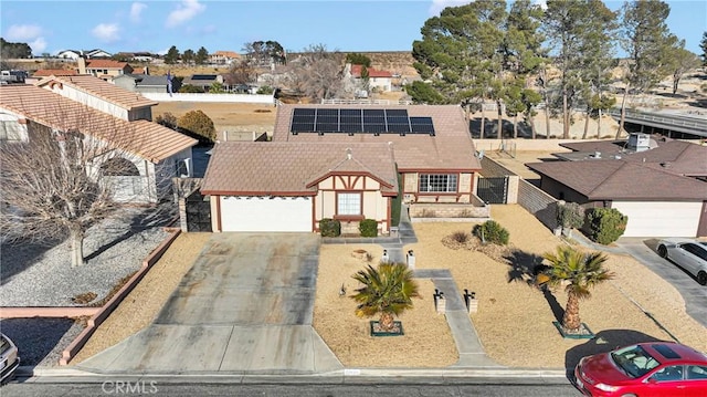 view of front of home featuring a garage and solar panels