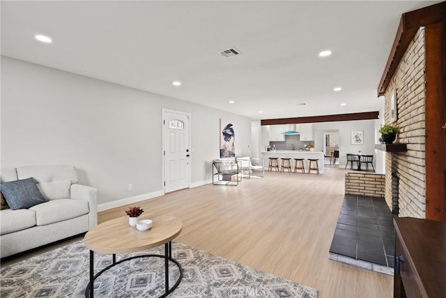 living room featuring a fireplace and light hardwood / wood-style floors