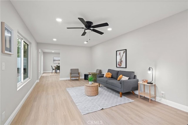 living room featuring ceiling fan and light wood-type flooring