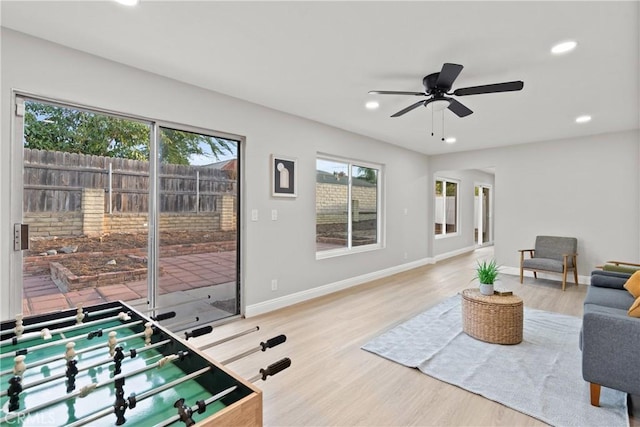 living room with hardwood / wood-style floors and ceiling fan