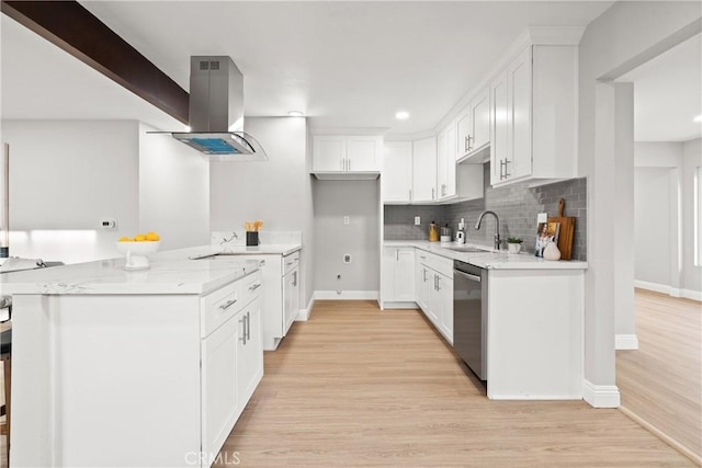 kitchen with island exhaust hood, stainless steel dishwasher, sink, and white cabinets