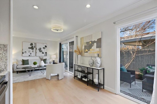 interior space with crown molding and light wood-type flooring