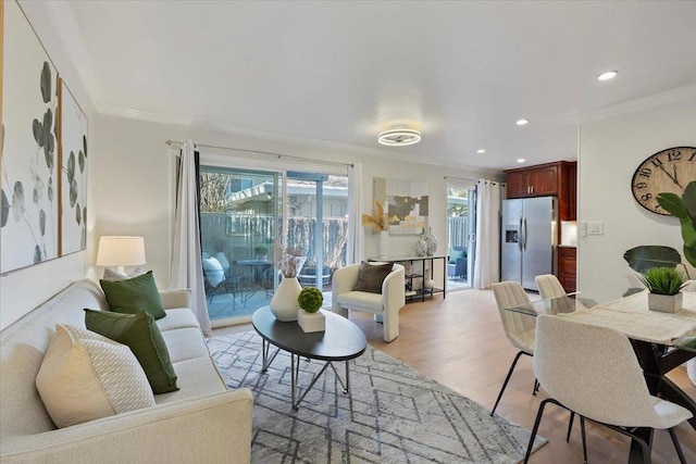 living room with crown molding and light hardwood / wood-style flooring