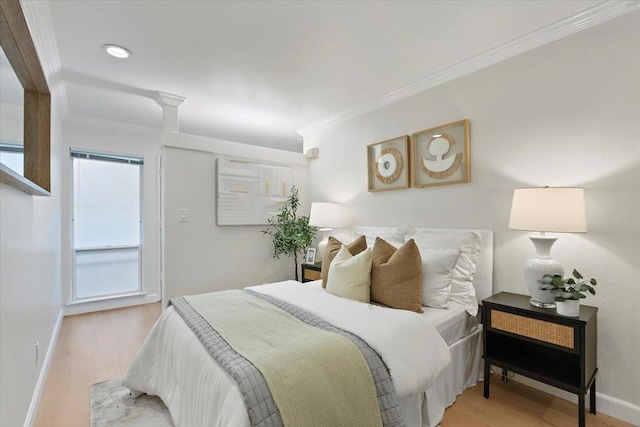 bedroom with ornamental molding and light wood-type flooring