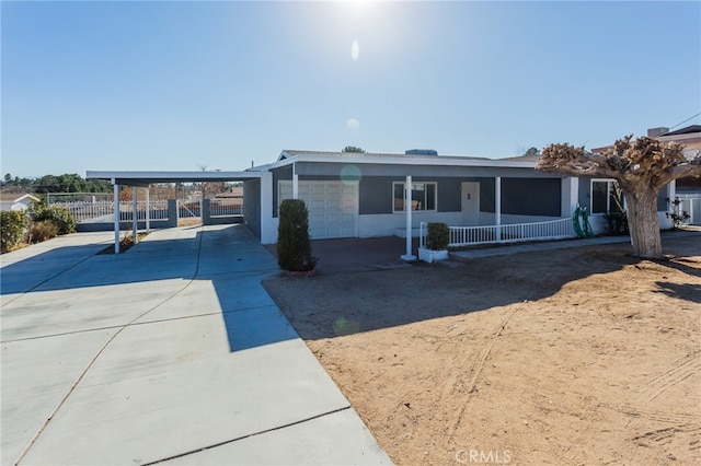 view of front of property with a garage and a carport