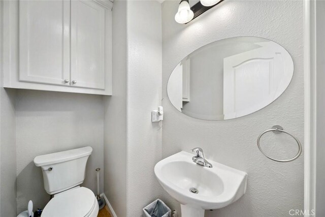 bathroom featuring sink and toilet