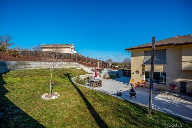 view of yard with an outdoor fire pit and a patio