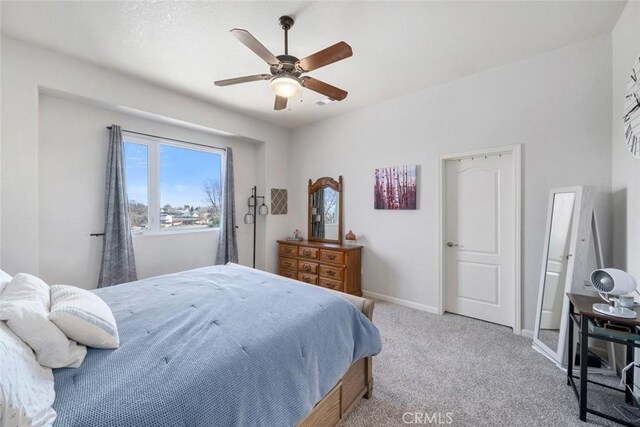 bedroom featuring ceiling fan and light carpet