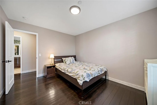 bedroom with dark hardwood / wood-style floors