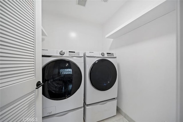 washroom with washing machine and dryer