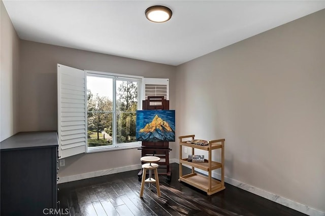 sitting room featuring dark wood-type flooring