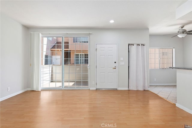 entryway with light wood-type flooring and ceiling fan