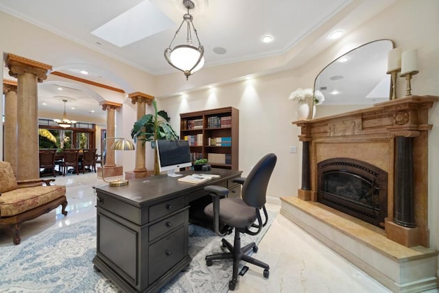 office area with decorative columns, crown molding, a premium fireplace, and a notable chandelier