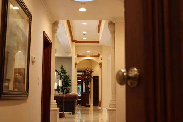 hall with crown molding and a raised ceiling