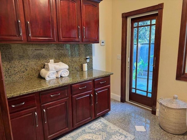 kitchen with dark stone counters and decorative backsplash