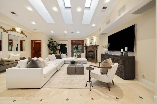 living room with ornamental molding and a skylight