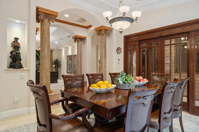 dining room featuring ornate columns, crown molding, and a notable chandelier