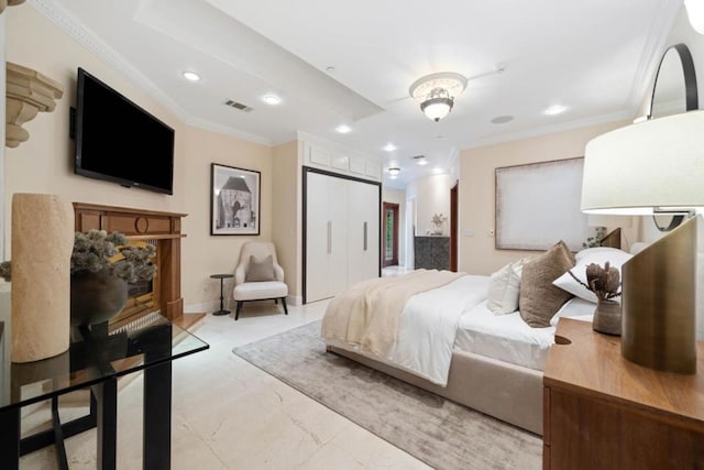 bedroom with crown molding and a closet