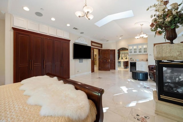 bedroom with lofted ceiling with skylight, a multi sided fireplace, wine cooler, ornamental molding, and a chandelier