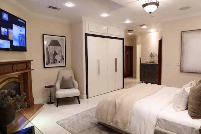 tiled bedroom with ornamental molding and a closet