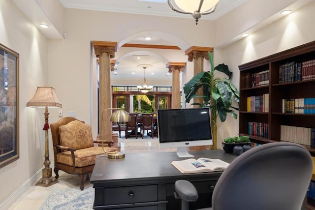 office area with a notable chandelier, crown molding, and ornate columns