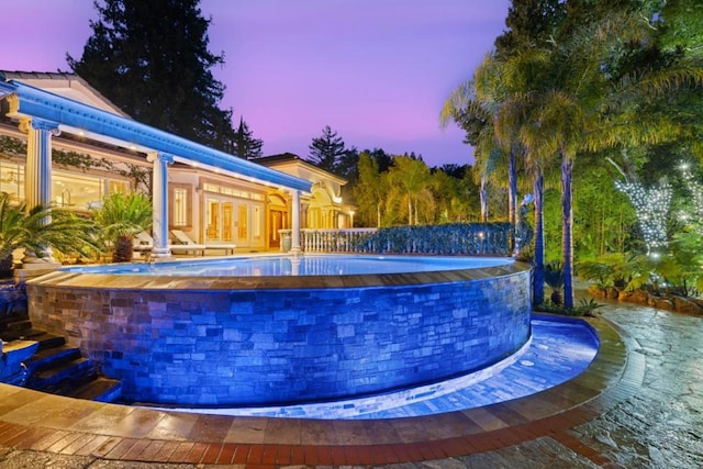 view of pool at dusk