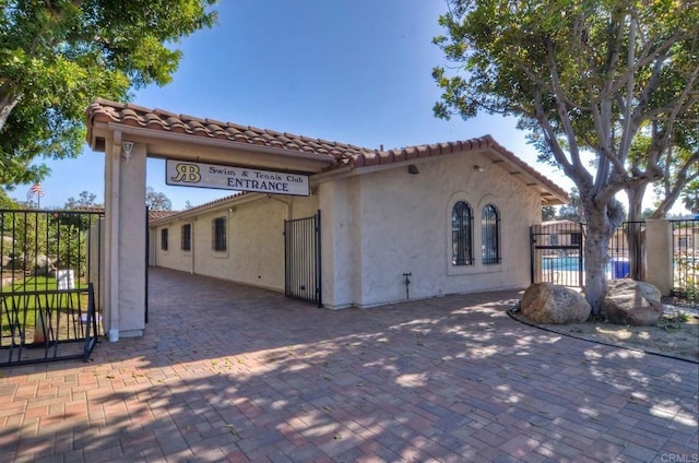 view of property exterior featuring a fenced in pool