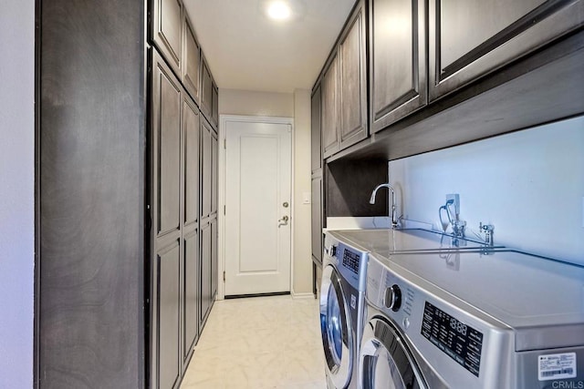 laundry area featuring cabinets, sink, and washing machine and clothes dryer