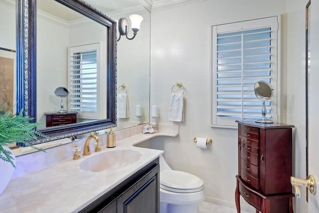 bathroom featuring ornamental molding, toilet, and vanity