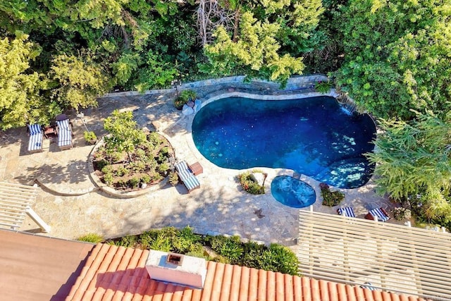 view of swimming pool featuring an in ground hot tub