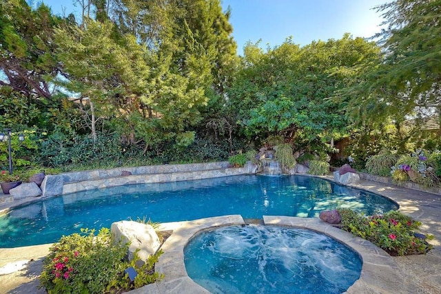 view of pool with an in ground hot tub