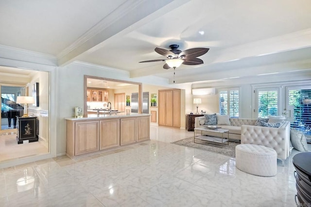 living room with sink, ornamental molding, and ceiling fan