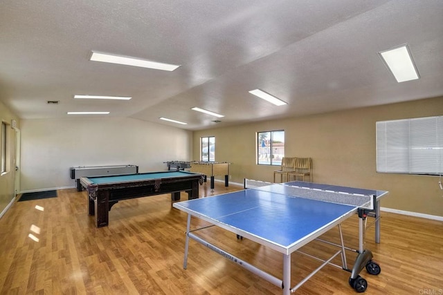 rec room with billiards, lofted ceiling, and light hardwood / wood-style flooring