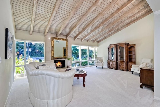 carpeted living room with wood ceiling, a fireplace, high vaulted ceiling, and beam ceiling