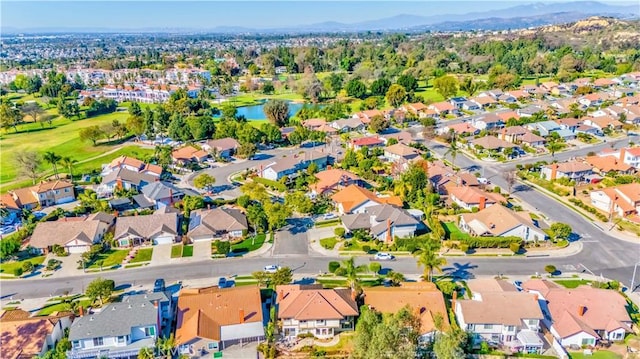 birds eye view of property with a water and mountain view