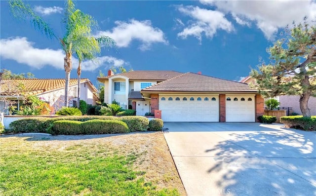 view of front of home featuring a garage and a front yard