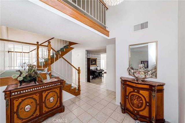 tiled foyer entrance with a high ceiling