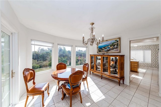 tiled dining area featuring a notable chandelier