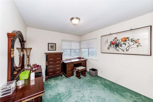 carpeted office featuring a textured ceiling