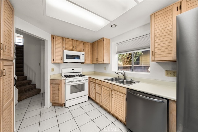 kitchen featuring sink, light brown cabinets, light tile patterned floors, and stainless steel appliances