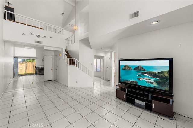 living room featuring high vaulted ceiling and light tile patterned floors