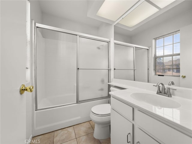 full bathroom featuring shower / bath combination with glass door, vanity, toilet, and tile patterned flooring