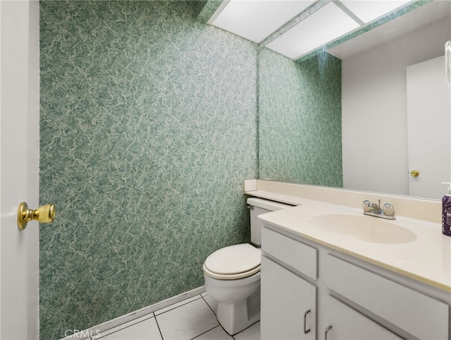 bathroom featuring toilet, tile patterned flooring, and vanity