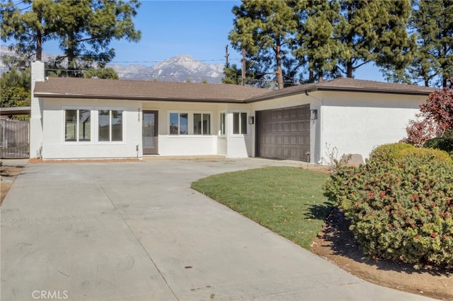 ranch-style house featuring a mountain view and a garage