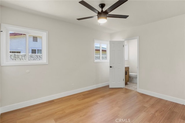 spare room with ceiling fan and light wood-type flooring