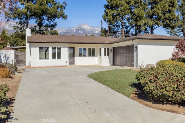 ranch-style home with a garage and a mountain view