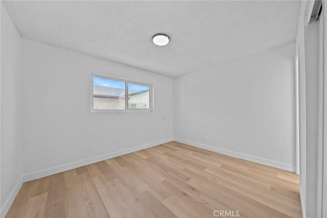 unfurnished room with light wood-type flooring